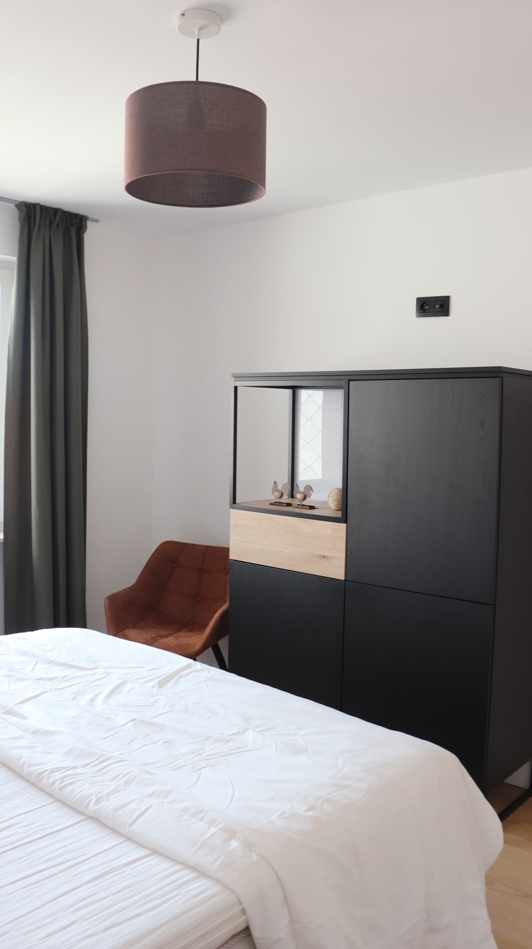 Bedroom corner with leather armchair and display cabinet